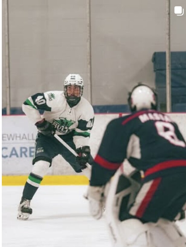 Ice hockey forward driving toward the goaltender