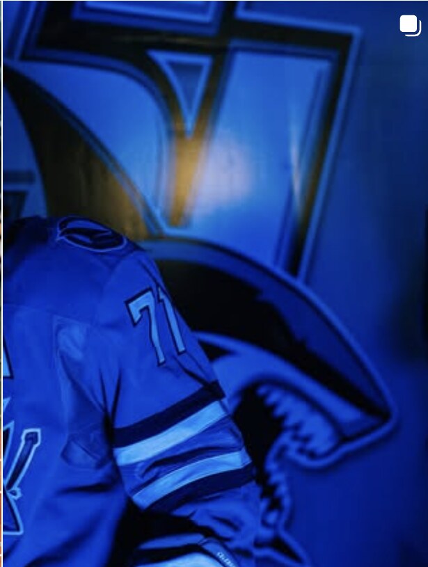 Athlete in blue jersey backlit before the event